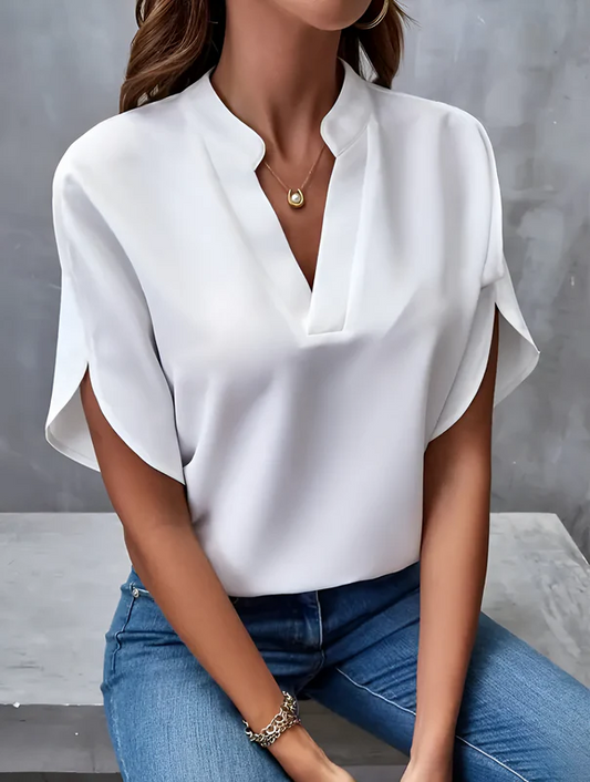 Women’s white soft V-neck blouse with a relaxed fit and long gathered sleeves, made from a breathable polyester-cotton blend, suitable for layering or stand-alone wear in everyday and professional settings.

